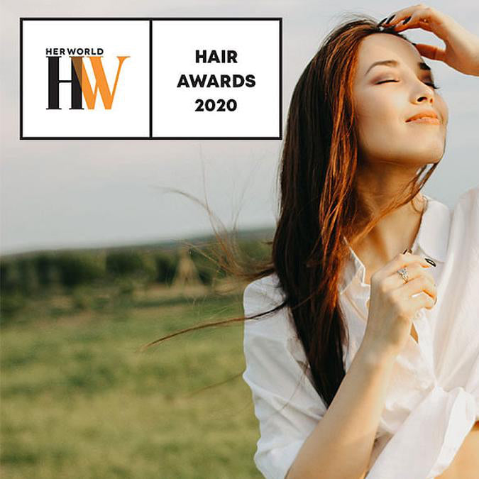 Woman enjoying nature with healthy windblown hair featured in Her World Hair Awards 2020