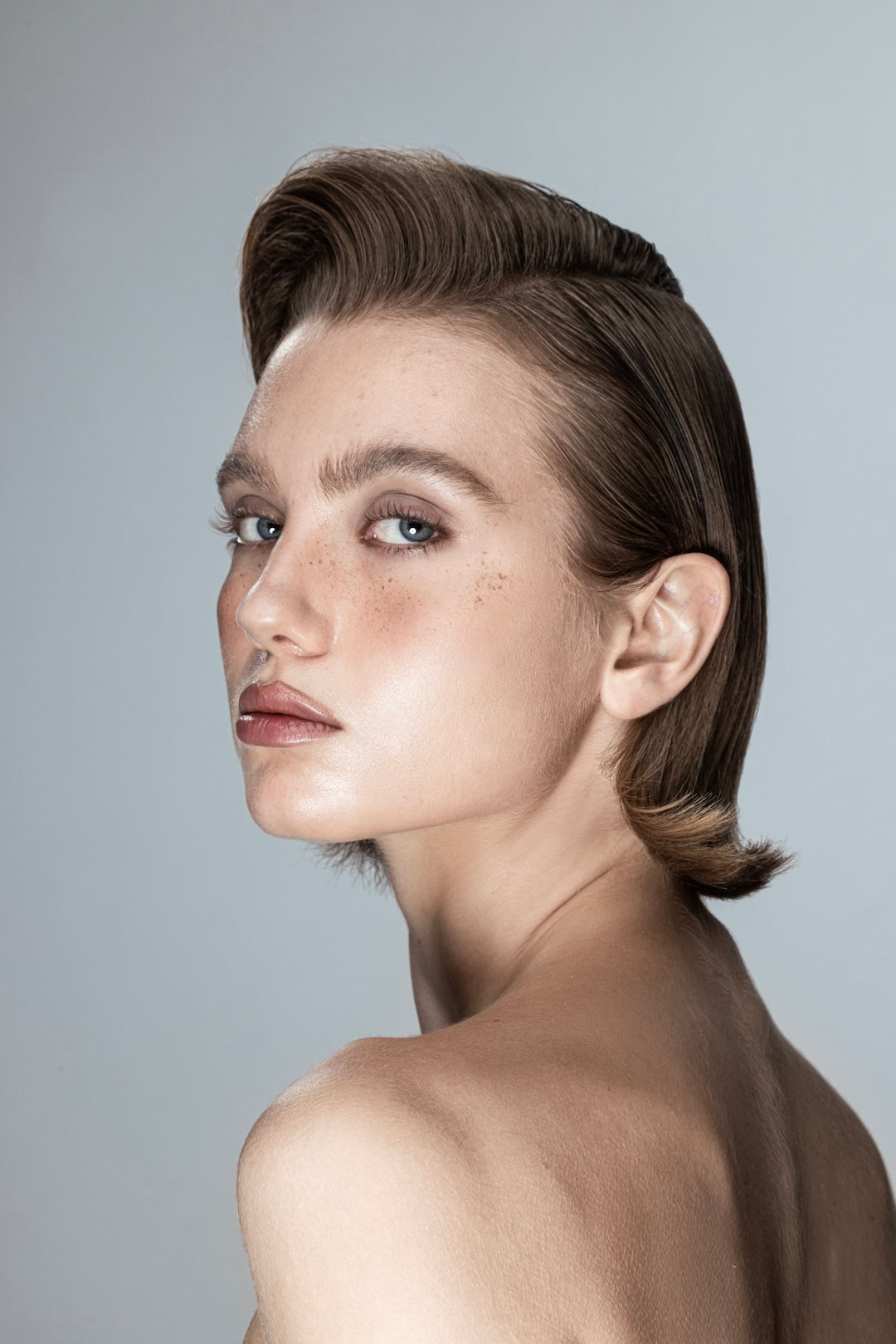 Model with sleek brown slicked-back hairstyle for Yann Beyrie VIP packages