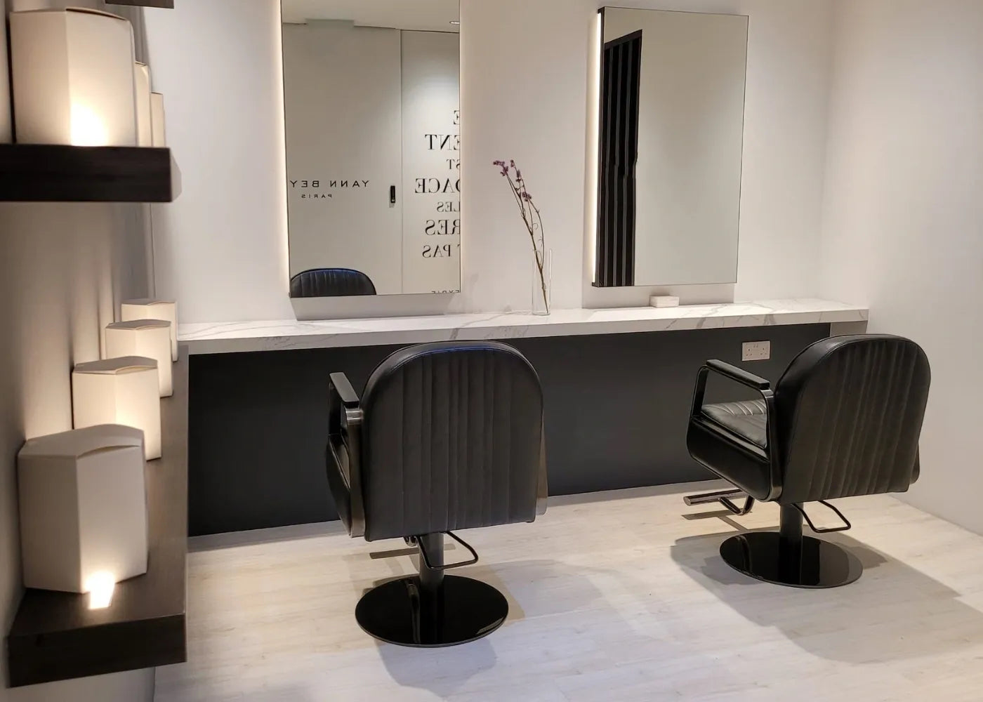 Private VIP hair styling room with minimalist mirrors and leather chairs at Yann Beyrie Paris
