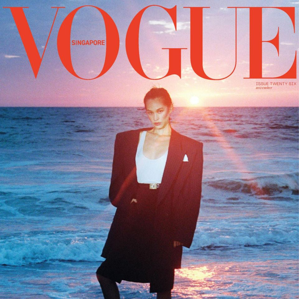 Model in black blazer on beach sunset for Yann Beyrie Paris advertisement in Vogue Singapore